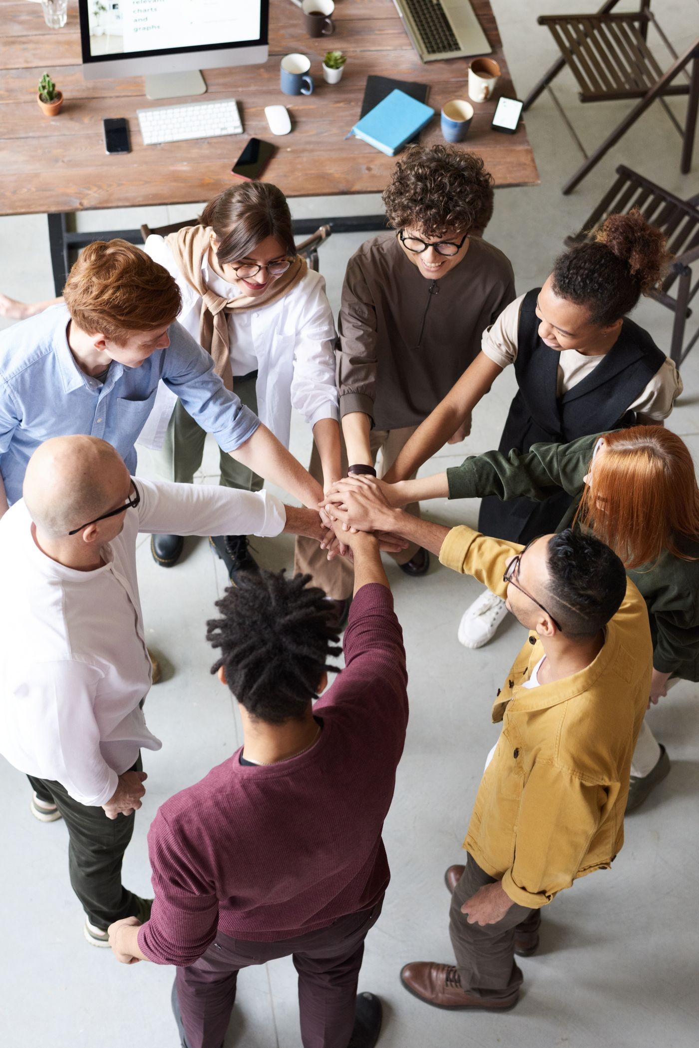 Team members bringing their hands together