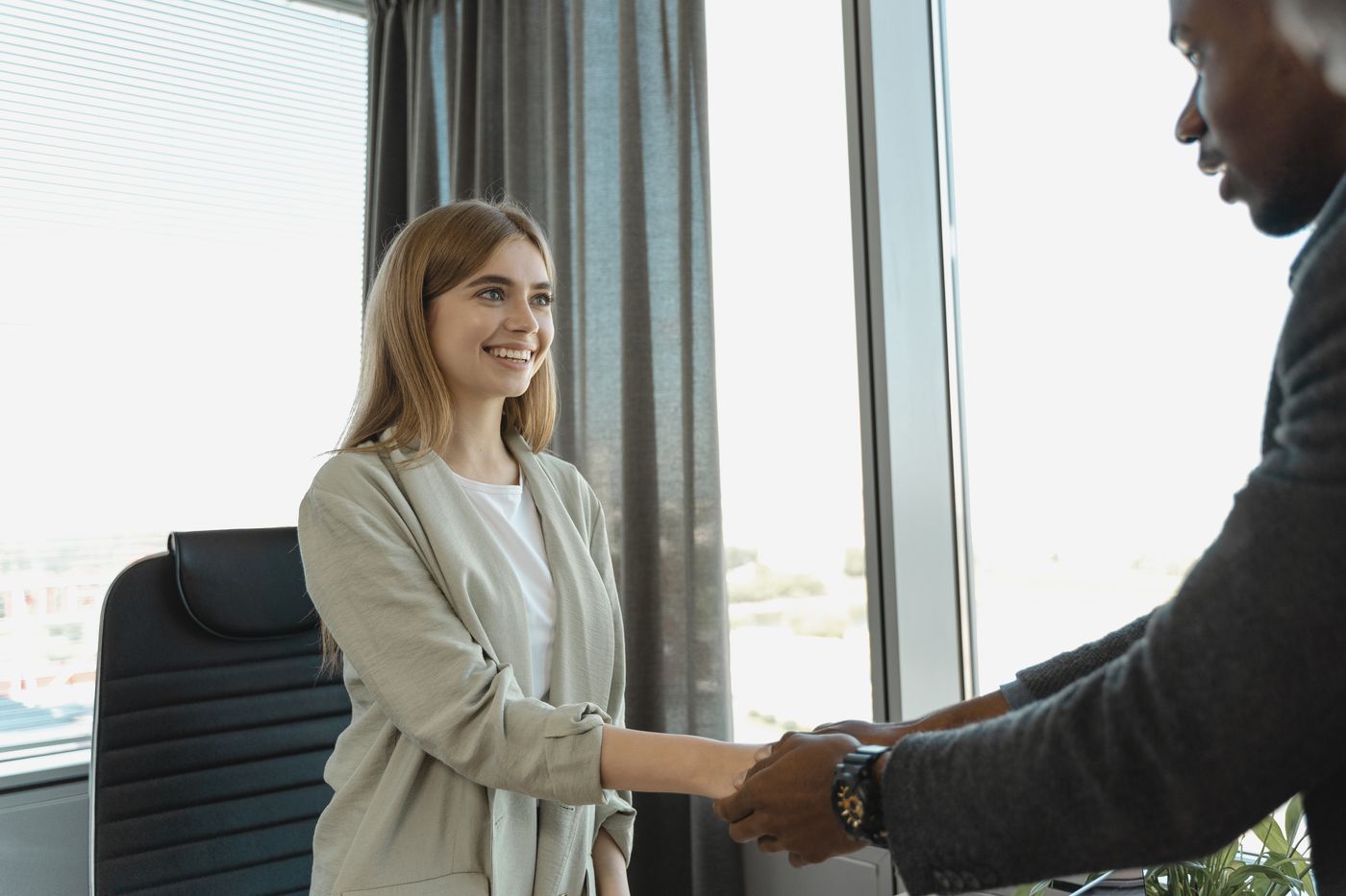 Two professionals greeting each other in an office