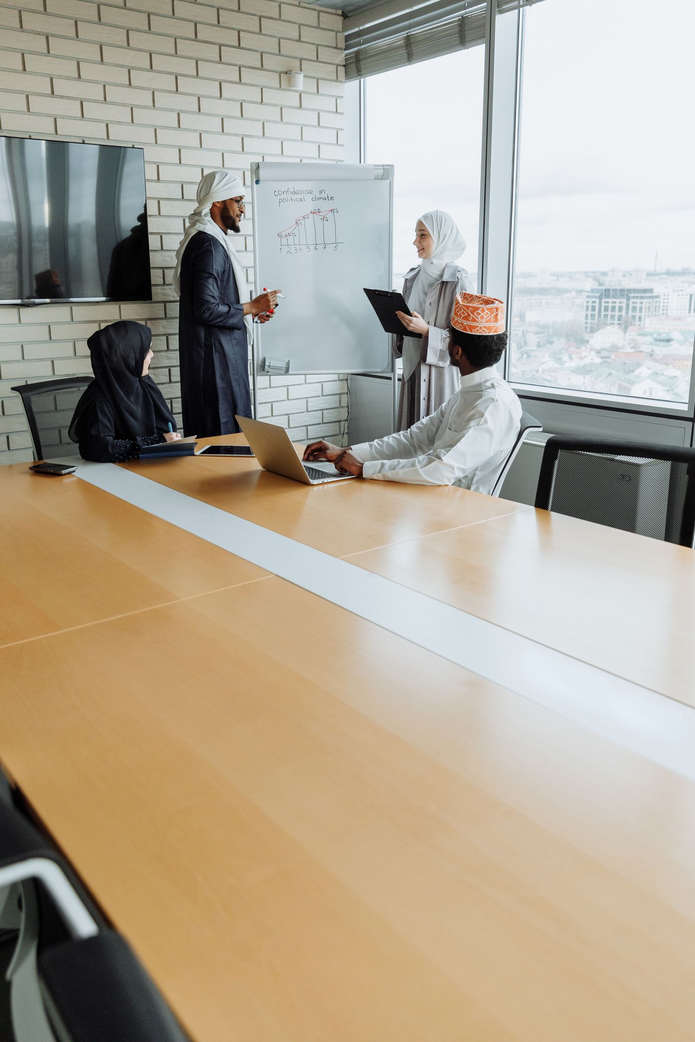 Professionals discussing work around a meeting table